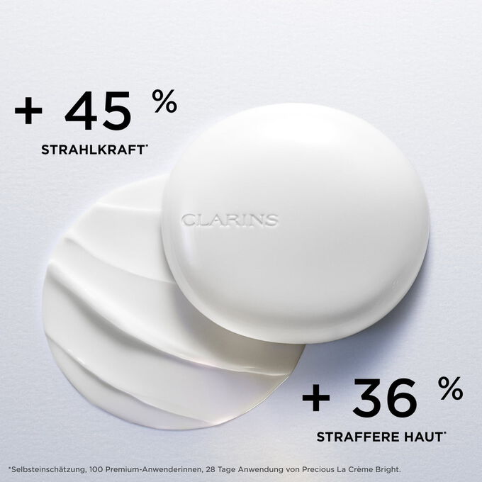 Tiegel Clarins Precious Brightening Face Moisturizer, bei dem die hautstraffende und Ausstrahlung f&ouml;rdernde Wirkung hervorgehoben wird.