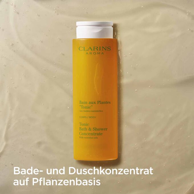 Packshot von Clarins Pflanzenbad Tonic mit Text, der betont, dass es sich um ein aromatisches Duschgel auf Pflanzenbasis handelt.