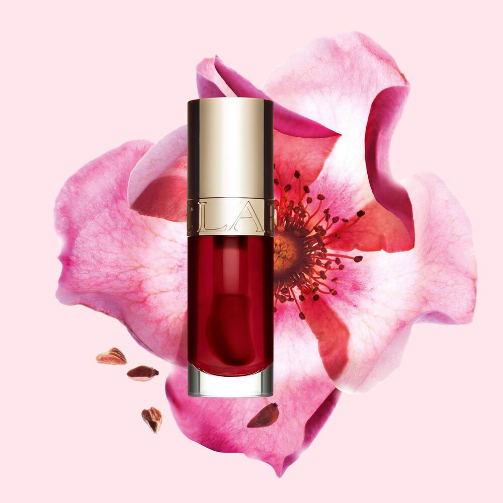 Huile Confort Lèvres 03 Cherry aux bienfaits pour la peau, devant fleur de rosier rouillé illustrant ses ingrédients naturels
