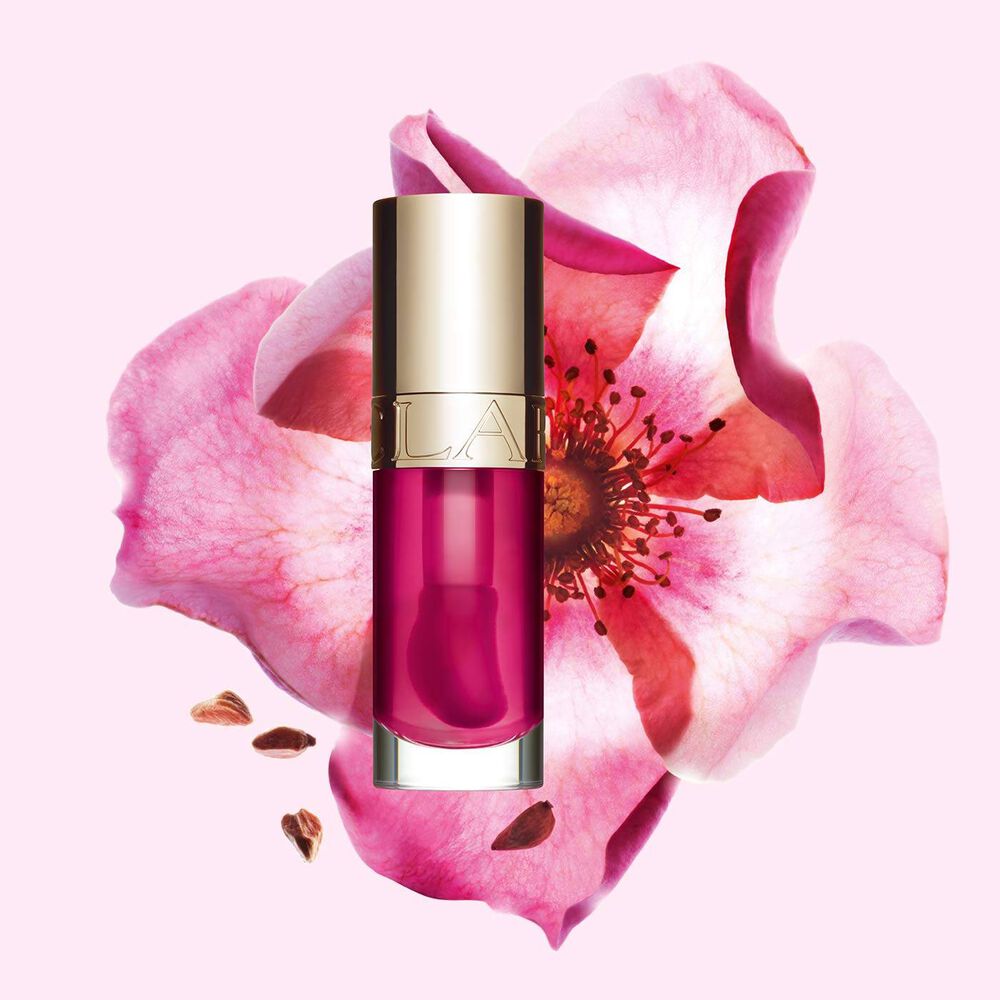 Plan produit de l'Huile Confort Lèvres 02 Raspberry avec une fleur de rosier rouillé, formule à base d'ingrédients naturels.