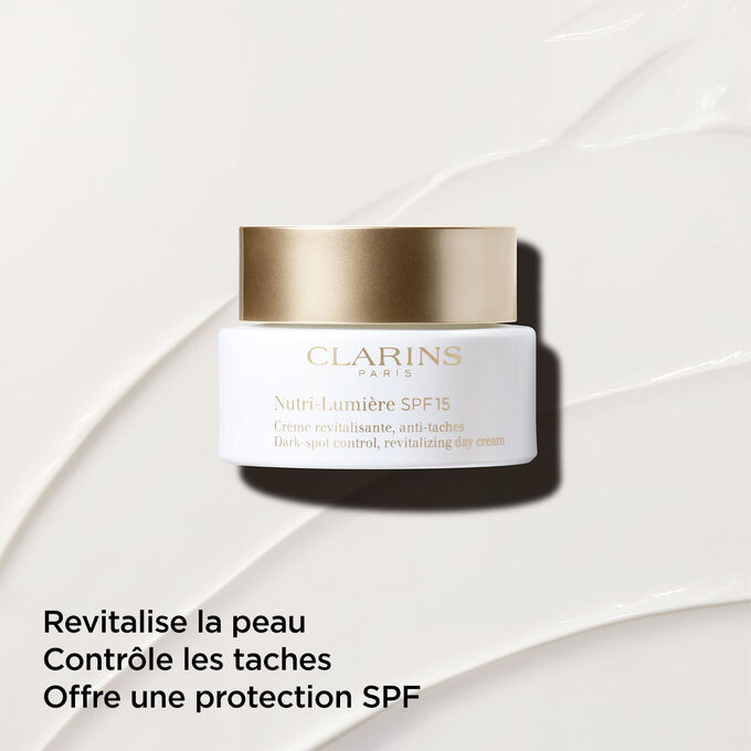 Crème de jour anti-taches avec SPF 15 sur fond texturé, mettant l'accent sur ses propriétés revitalisantes